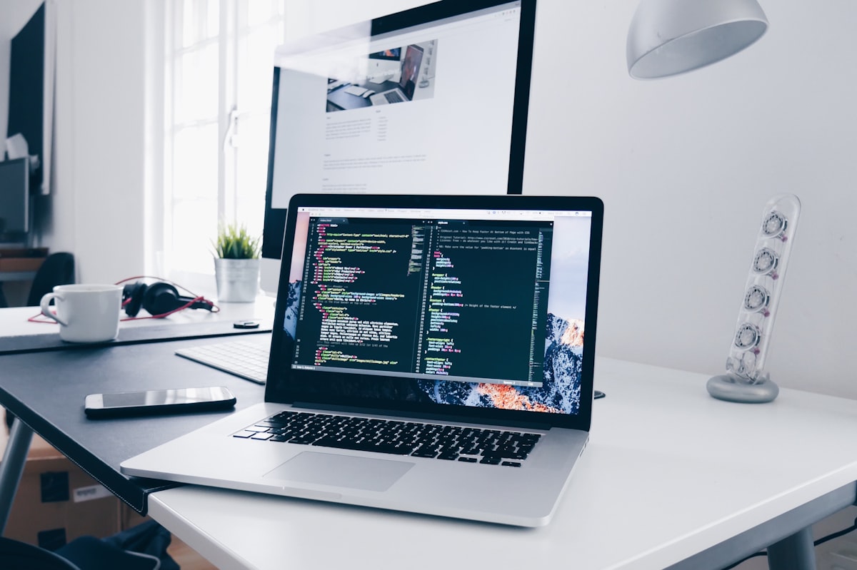 Business automation workflow being built on laptop - Make.com and Zapier integration development